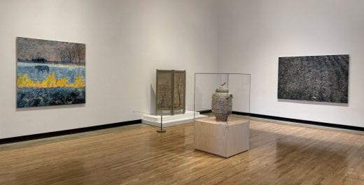 Paintings and sculptures displayed in a gallery at the Beach Museum of Art.