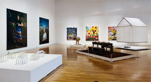 "Home/Land: Wahzhazhe Artists Speak" exhibition with sculptures , paintings and photographs displayed at the Beach Museum of Art.