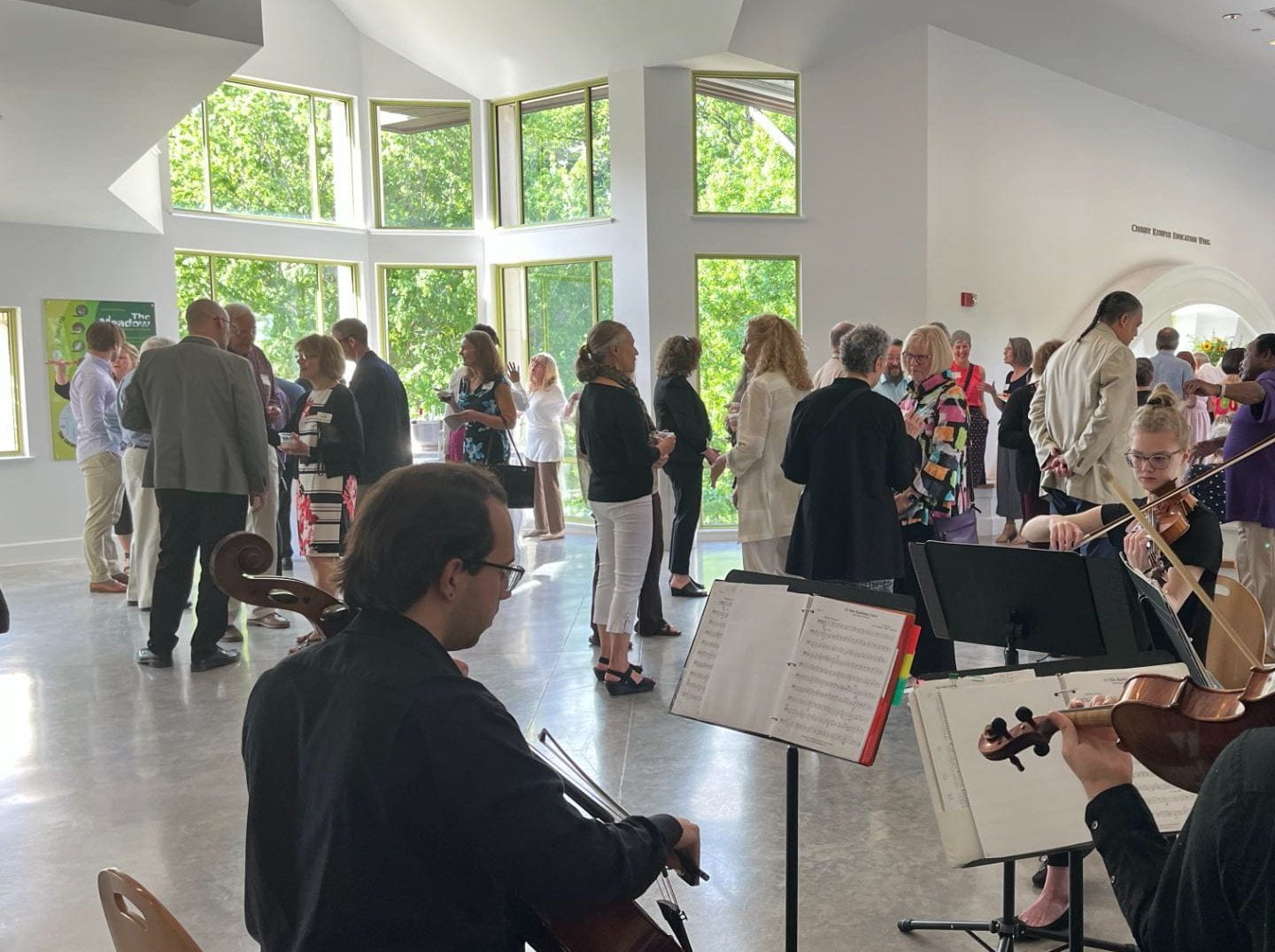 People mingling and socializing at a reception at the Beach Museum of Art.