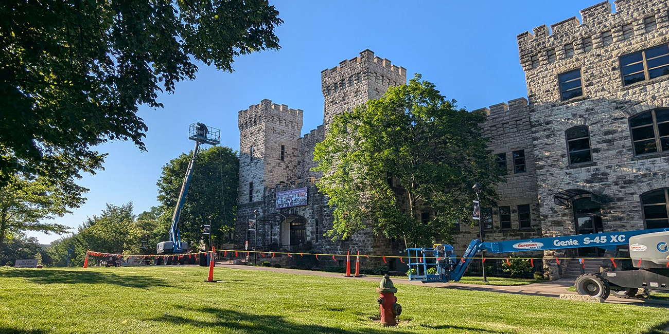 Limestone building blocked off with orange cones and flags