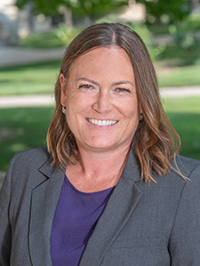 Kathy Huser smiles for a portrait.