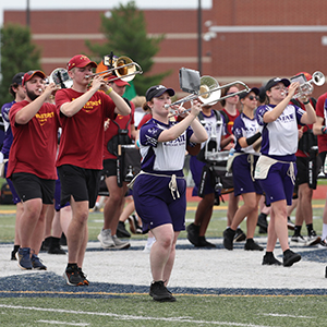 K-State and Iowa State band members playing and marching