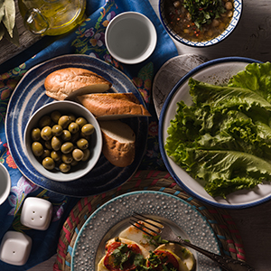 A top down view shows various Mediterranean dishes of rice, salmon and other similar foods.