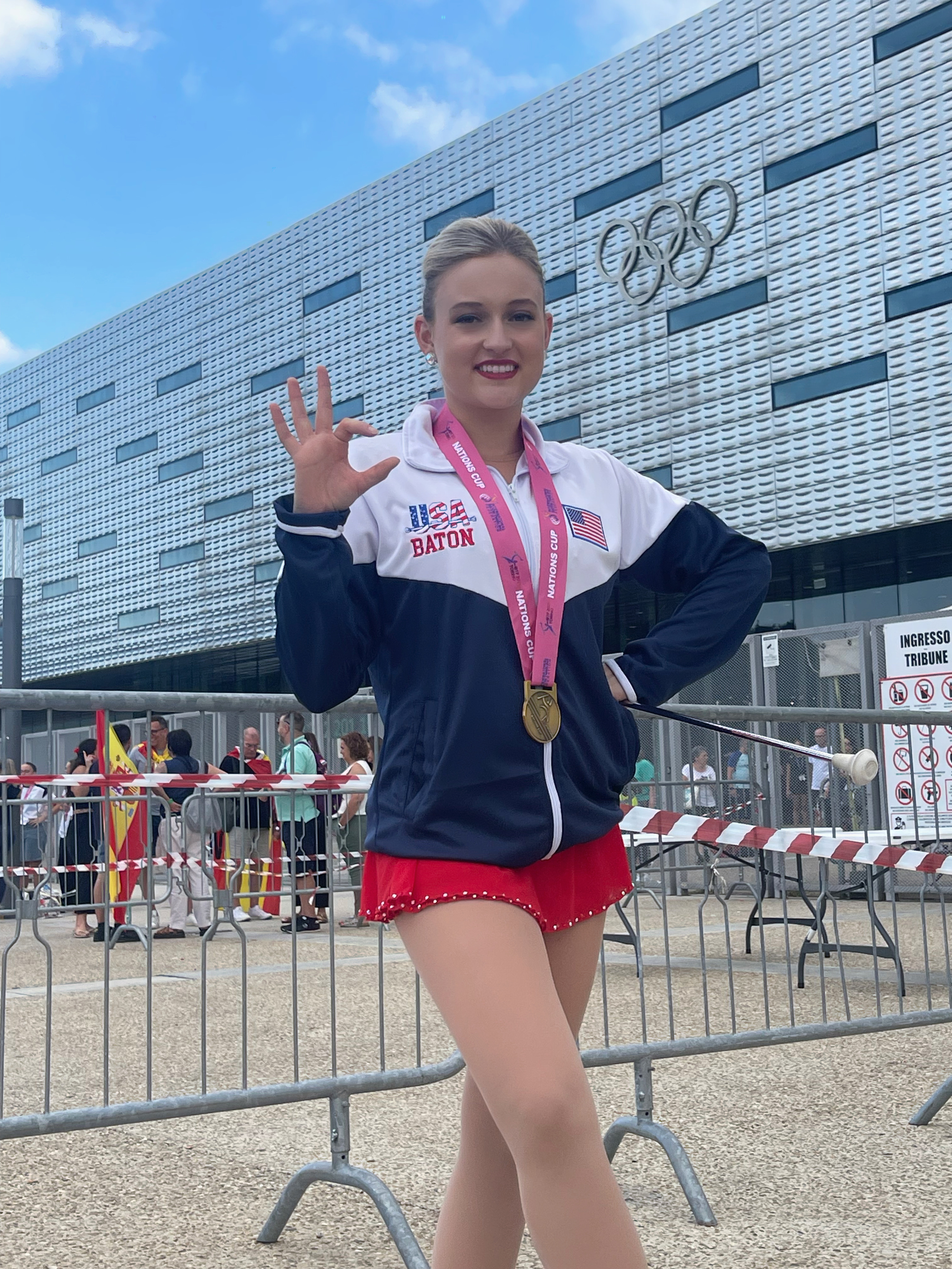 A woman in a twirler uniform poses for a photo. 