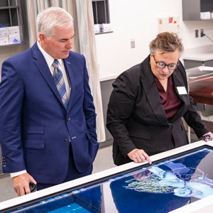 two people looking at high-tech equipment