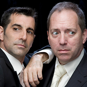 headshot of two men in black suits