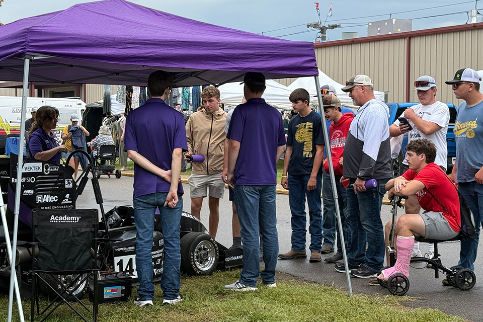 Powercat Motorsports students talk to Kansas State Fair attendees about their racecar. 