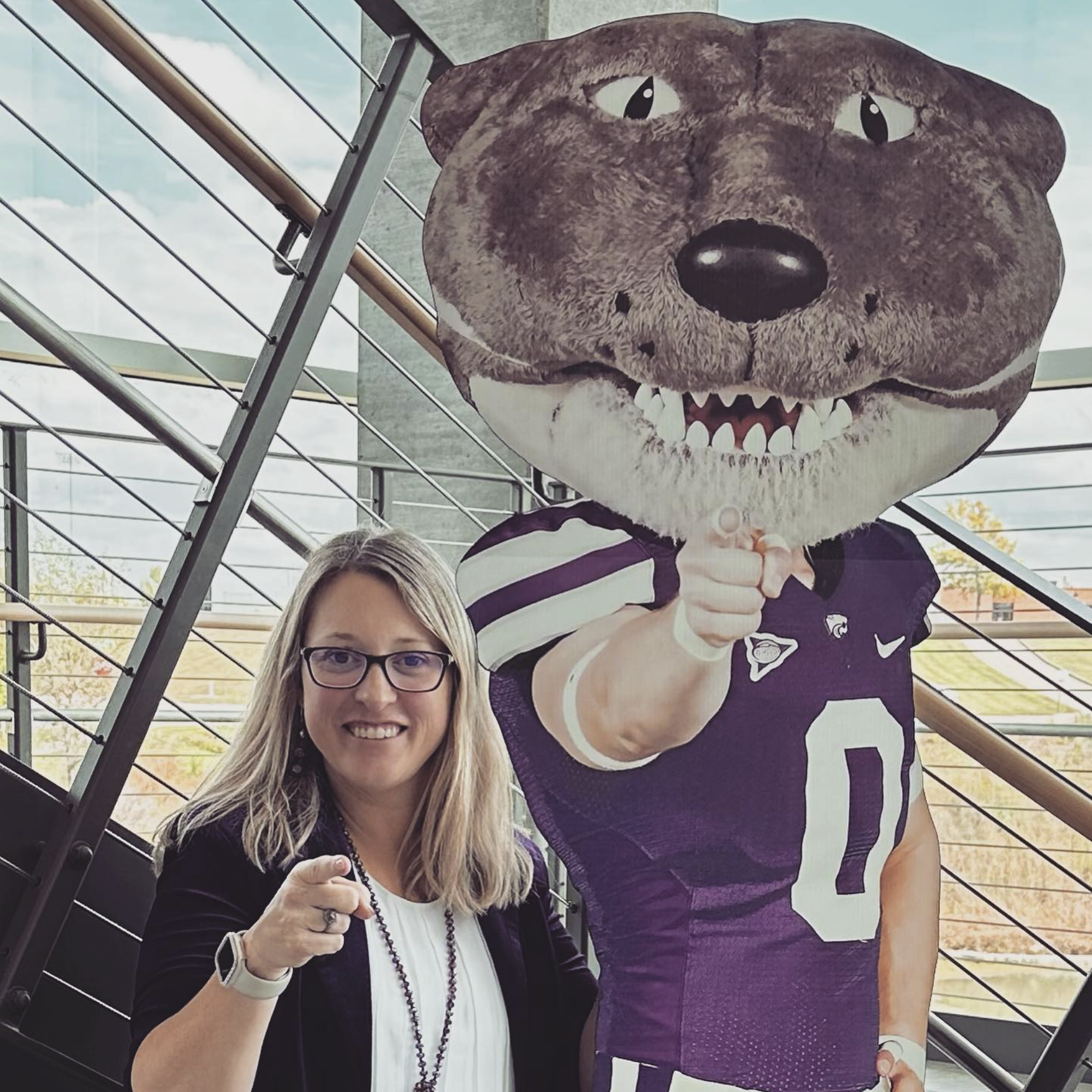 Jana Thomas poses for a portrait with Willie the Wildcat.