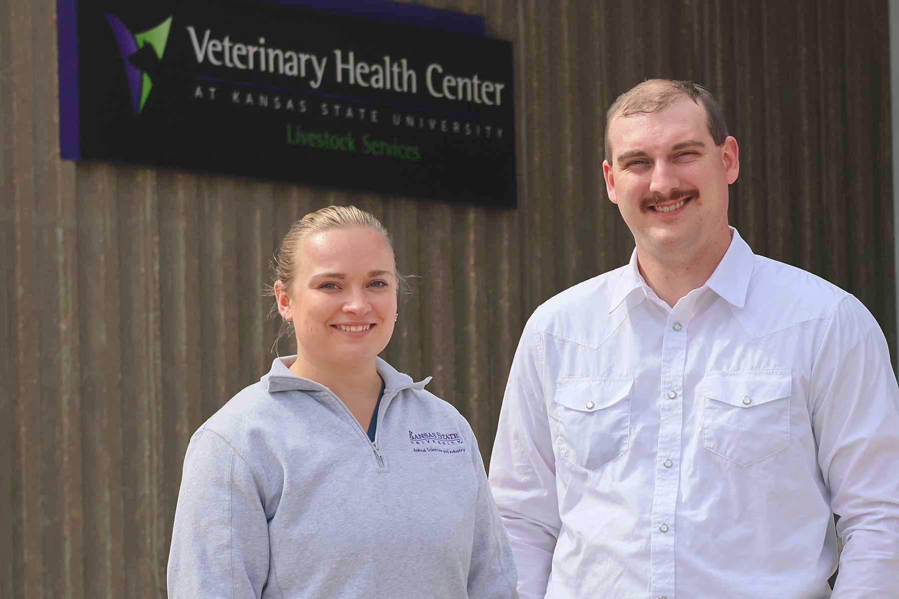 Two veterinary students at Kansas State University smile for a photo outside. 