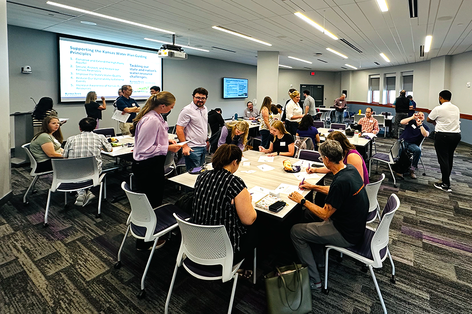 Interdisciplinary groups of students, staff, and faculty work together at a professional luncheon.