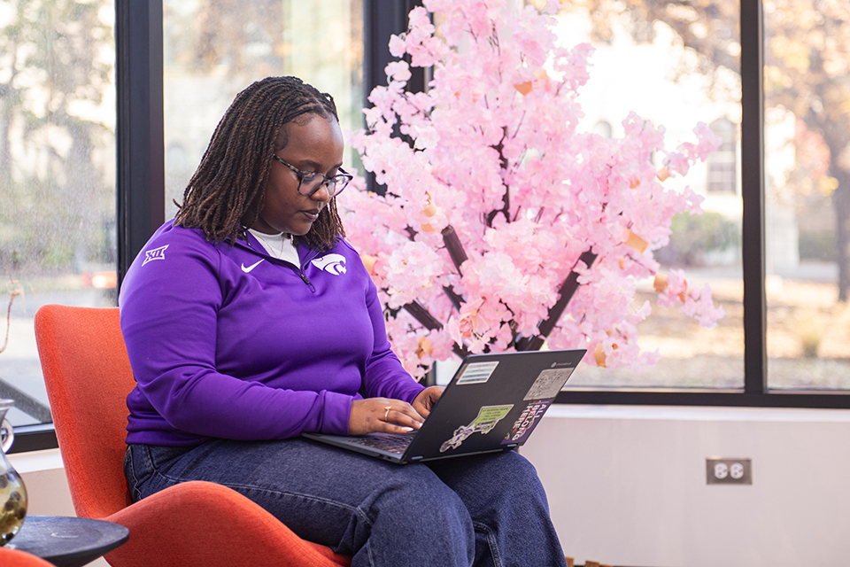 Brunealla Ishimwe sits in a brightly lit study area in a Multicultural Student Center.