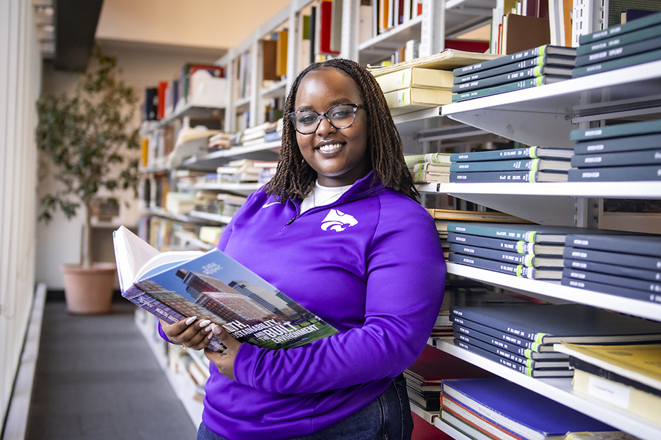 Brunealla Ishimwe sits in a brightly lit study area in a Multicultural Student Center.