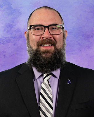 Craig McGill smiles for a portrait.