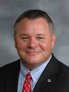 David renter smiles for a portrait.