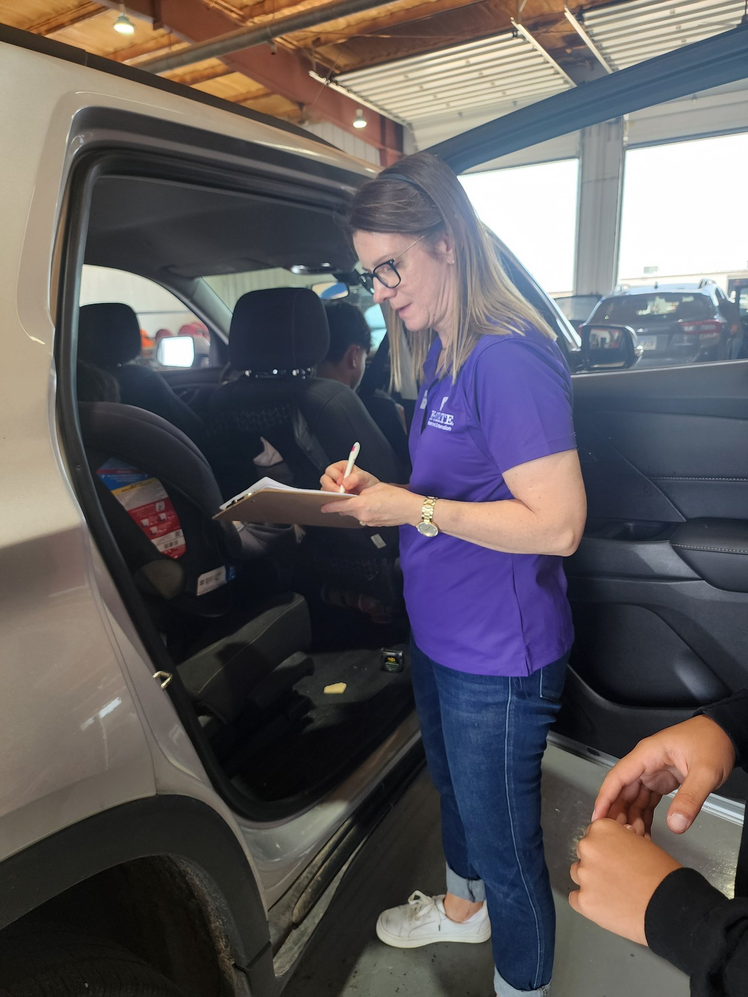 College professor Amanda Gaulke looks at a student from across a classroom table.