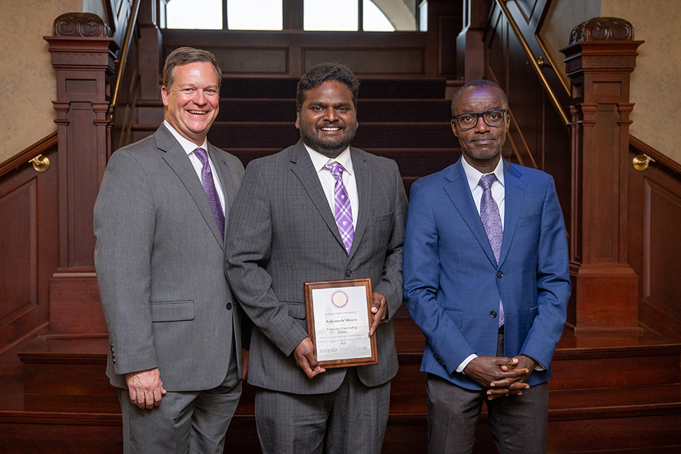 Kaliramesh Siliveru, standing alongside Dan Moser and Joseph Awika.