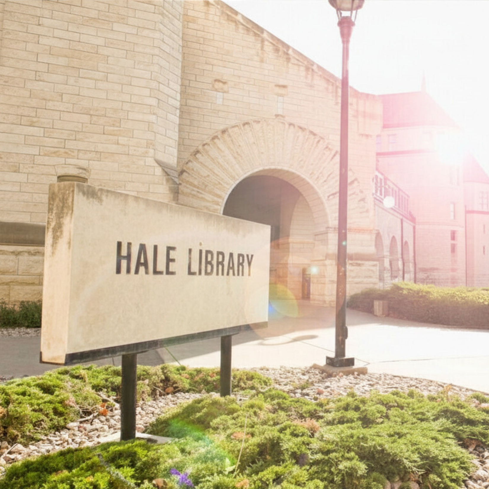 The outside front of Hale Library. There is a limestone sign in the bottom left corner displaying the building's name.
