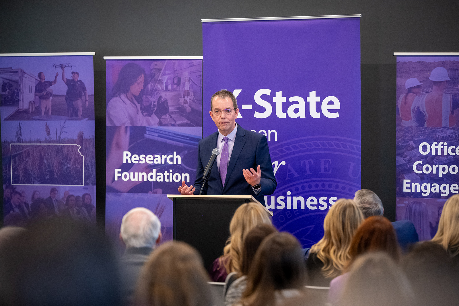 A man in a suit and tie gives a presentation 