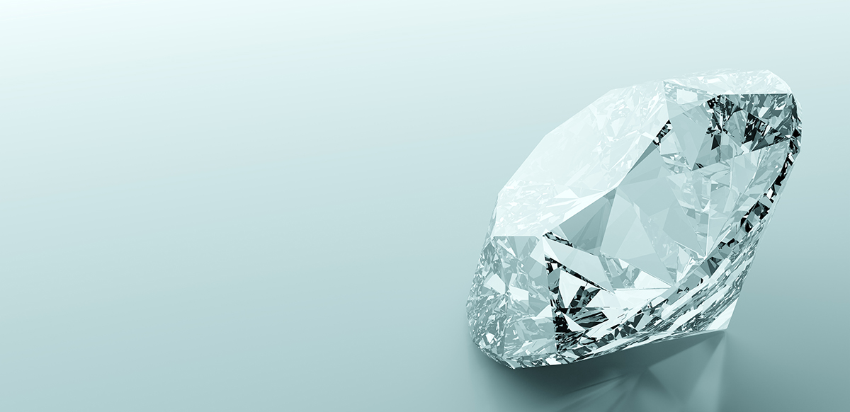 A diamond sparkles on the right side of a horizontal image against a light gray-blue background.
