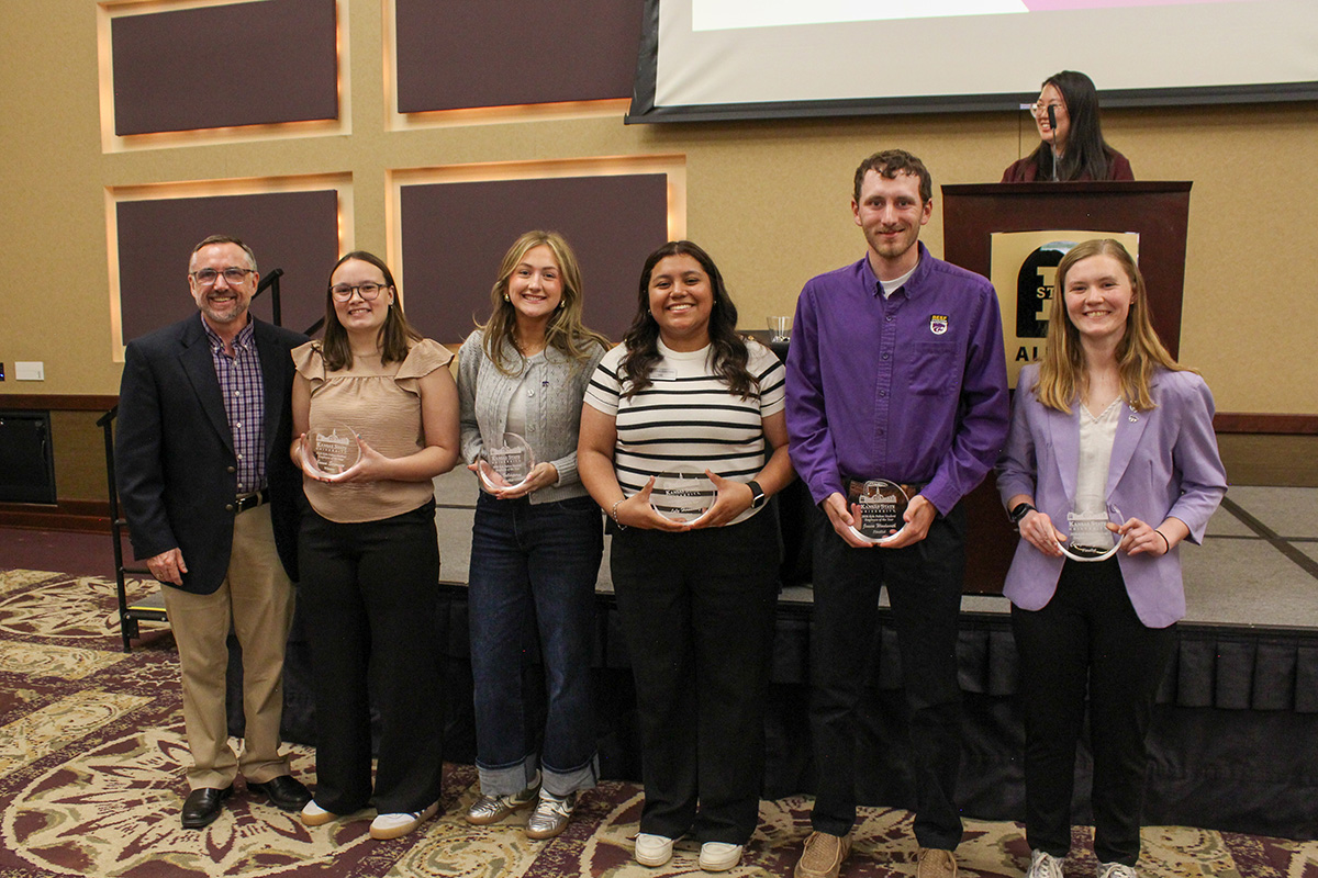 The five finalists for the Student Employee of the Year Award at Kansas State University receive their trophies at a ceremony. 