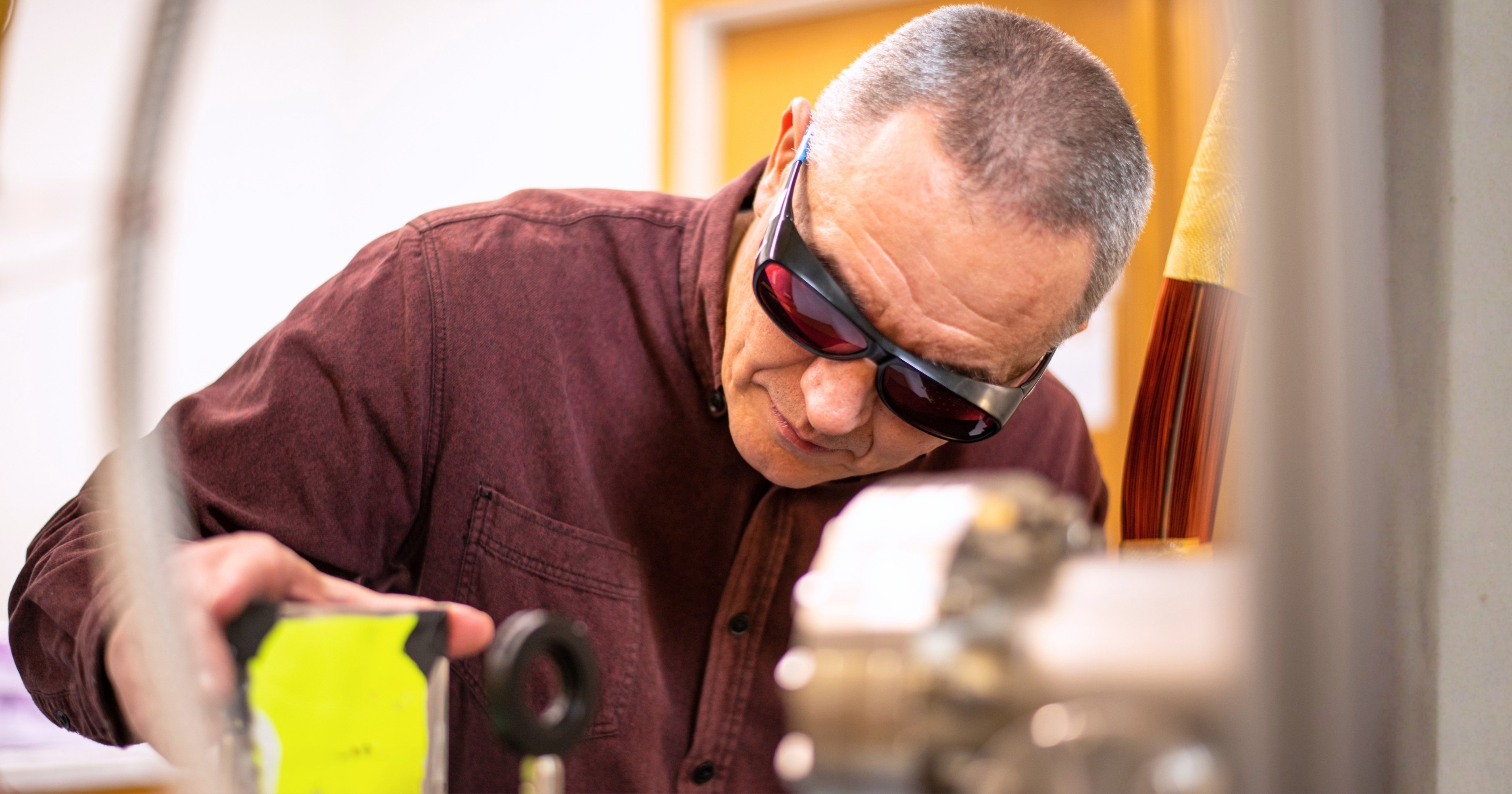 Artem Rudenko wears protective eyewear while working in the JRM laboratory