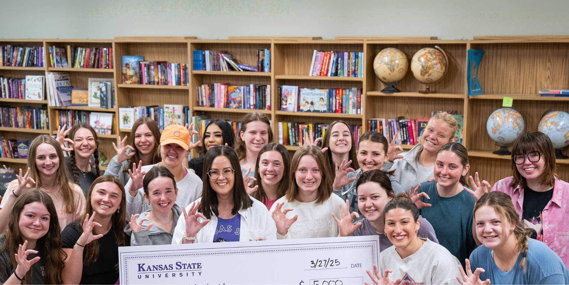 Kayln Hoppe and students pose for a photo after she won the 2025 Outstanding Undergraduate Teaching Award