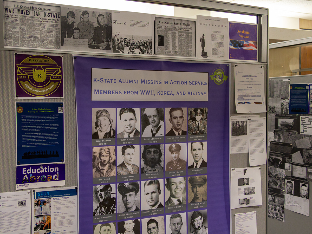 A bulletin board shows several materials, photographs and maps related to the K‑State MIA Project to find, identify and return missing service men from K‑State and Kansas over the past century.