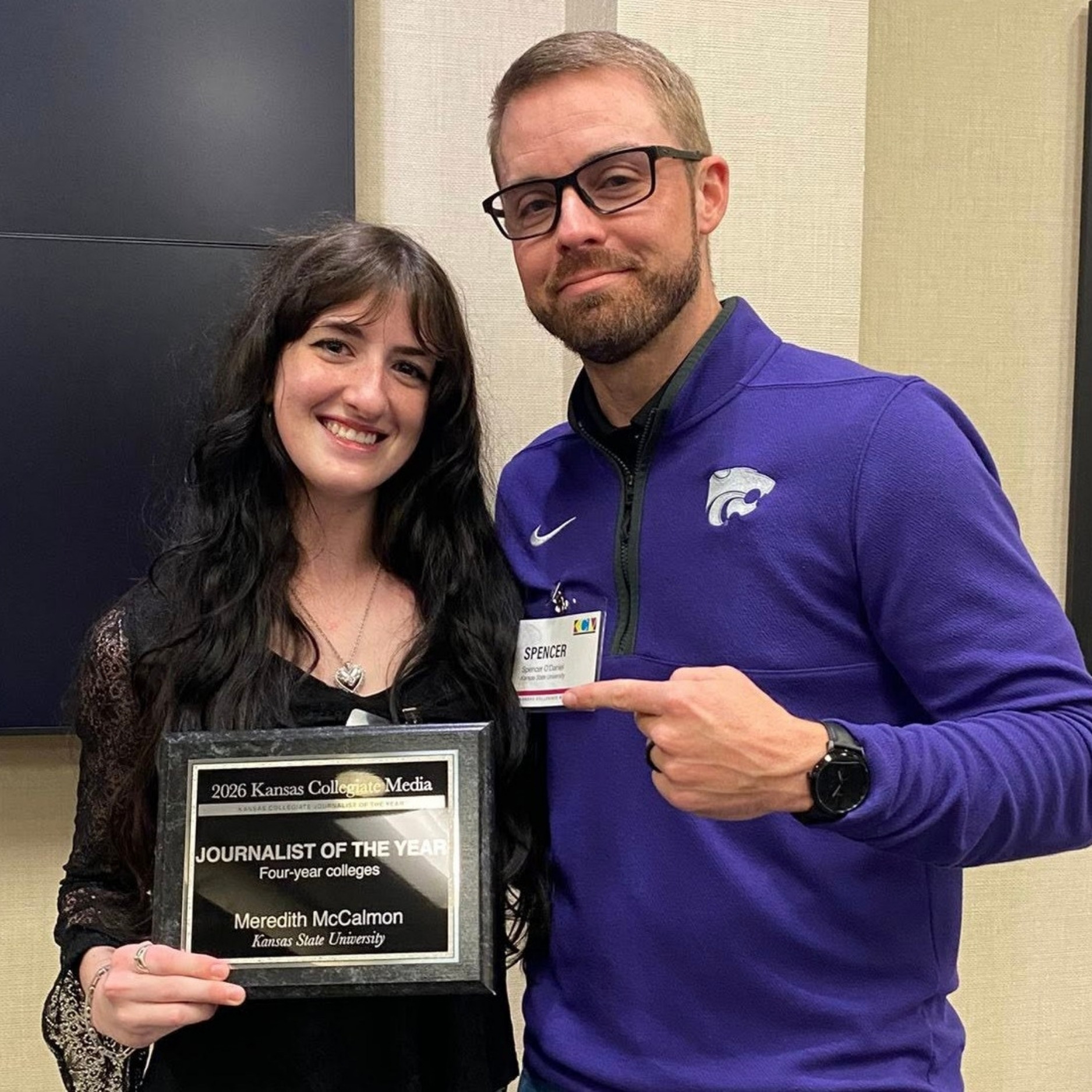 McCalmon poses with her commemorative plaque and her advisor.