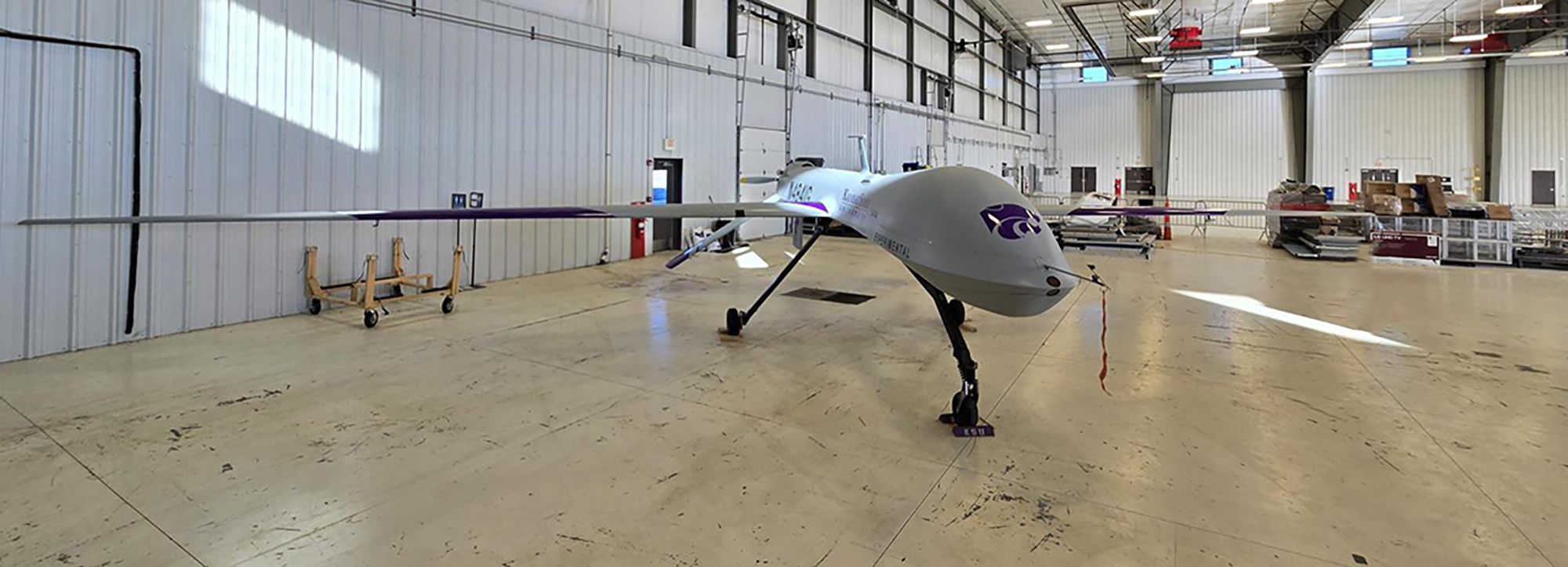 An uncrewed aircraft sits in a hangar.