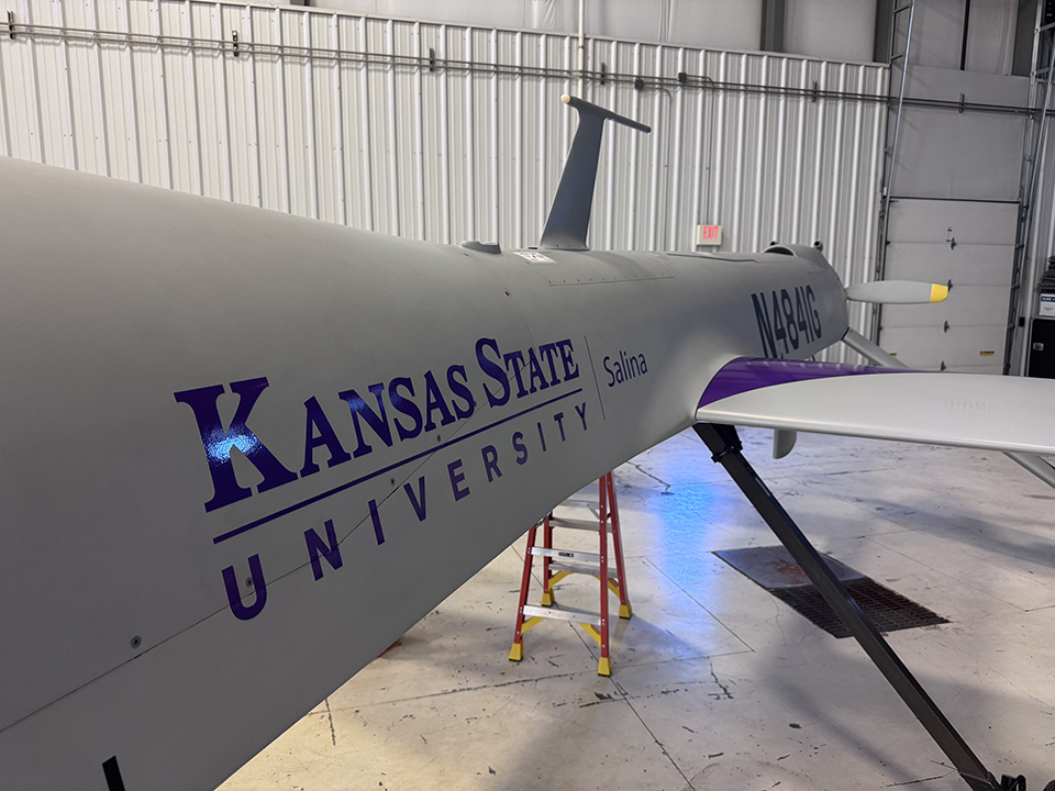 A close-up view of a gray uncrewed aircraft with the K-State Salina wordmark printed in purple.