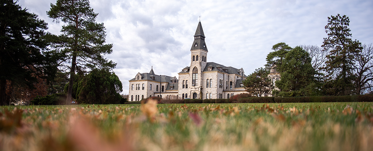 A castle-like limestone building, Anderson Hall, is pictured from ground angle. 