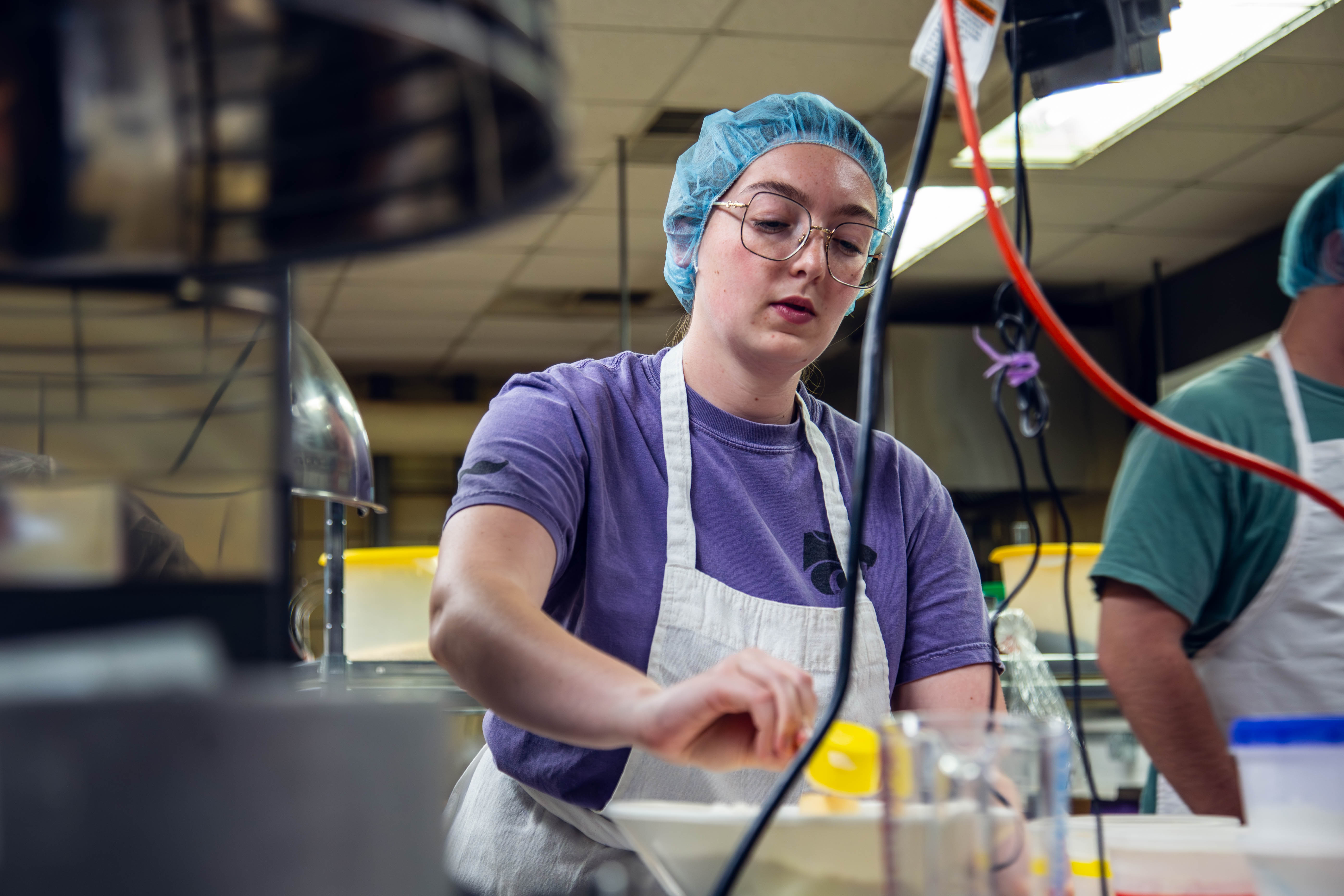 Addison Brandau measures out ingredients for an experimental sorghum muffin recipe.