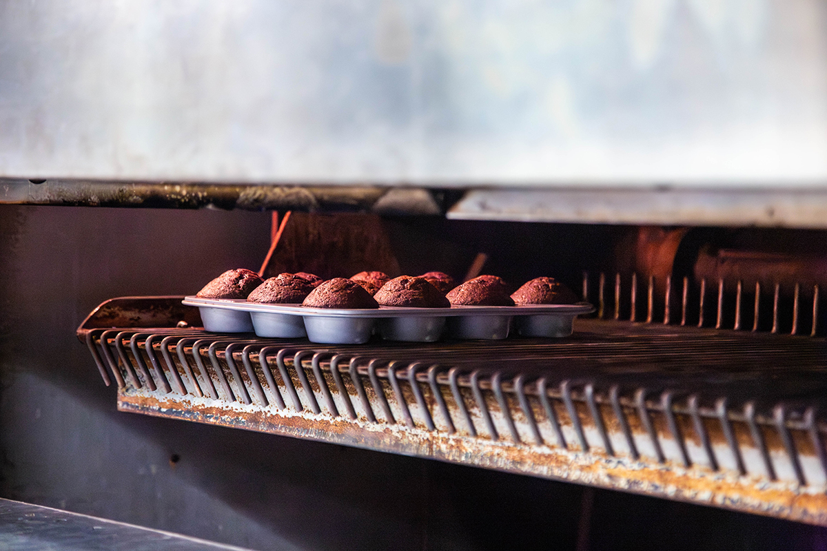 Chocolate muffins bake in a hot oven.