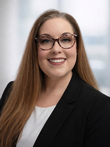 Brandi Smith smiles for a professional portrait. 