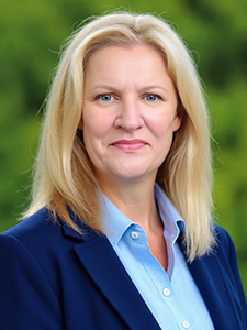 Kelley Brundage smiles for a professional portrait. 