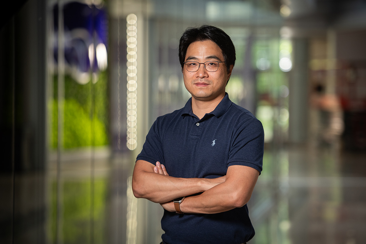 Won Min Park smiles for a professional portrait. 