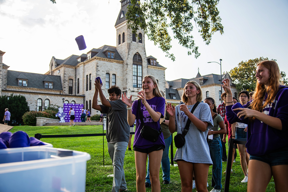 Students pick up purple shirts.