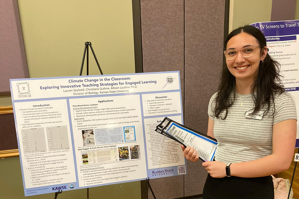 Lauren Seybold is standing next to a research presentation board. 