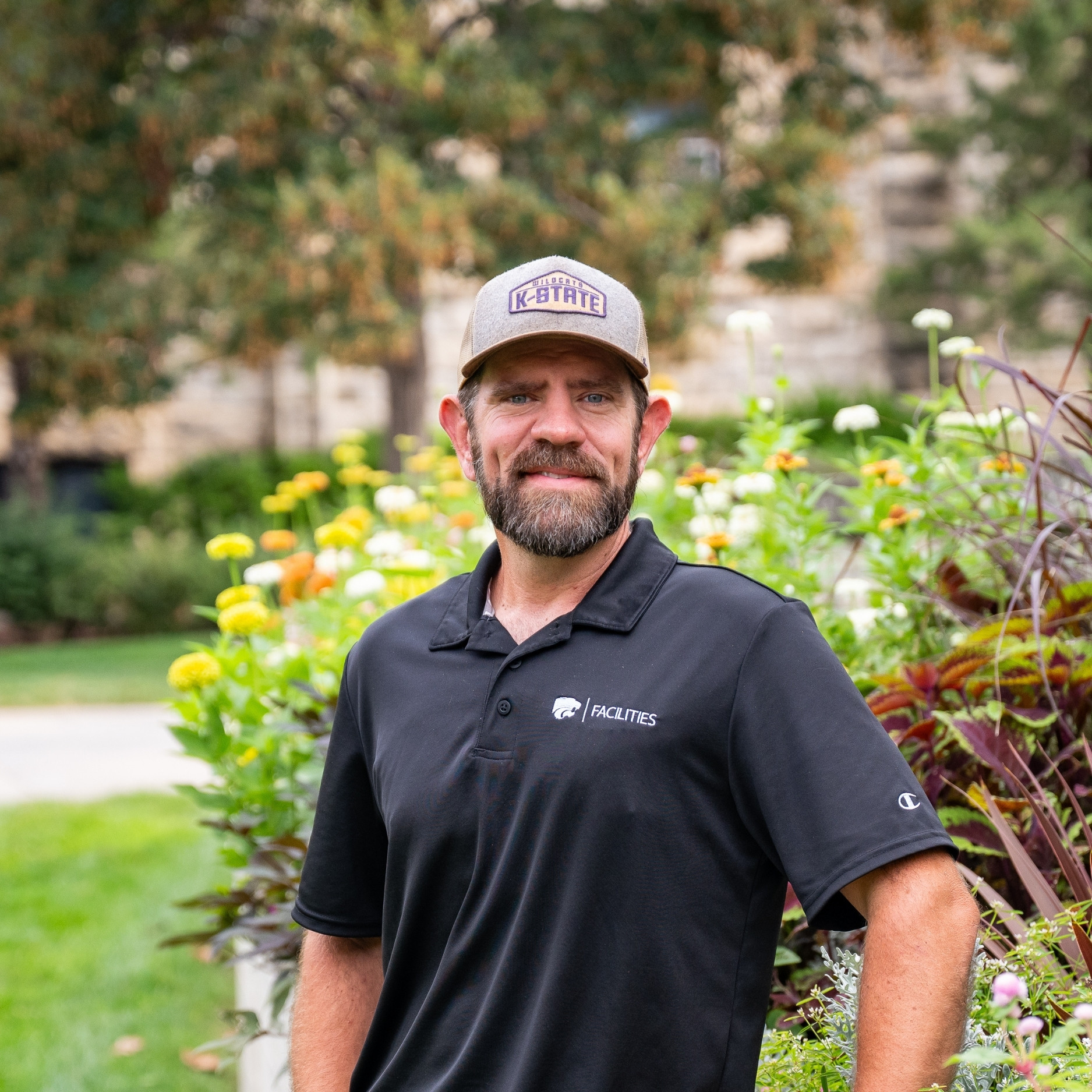 Steven Snyder stands next to a landscaping display outside of Bosco Plaza