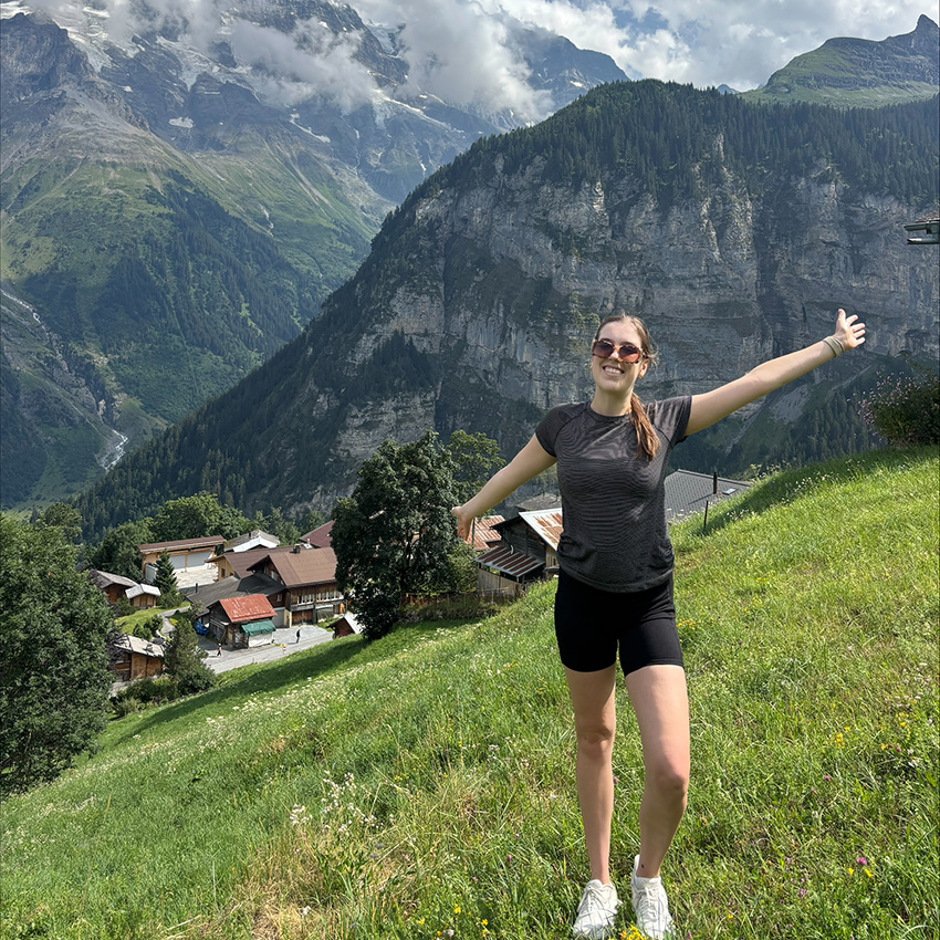 Alexa Palmer stands in front of the Swiss Alps. 
