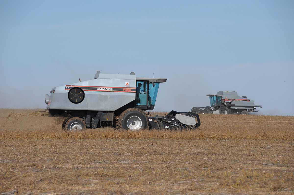 Two farm vehicles that run on diesel are pictured in a field.