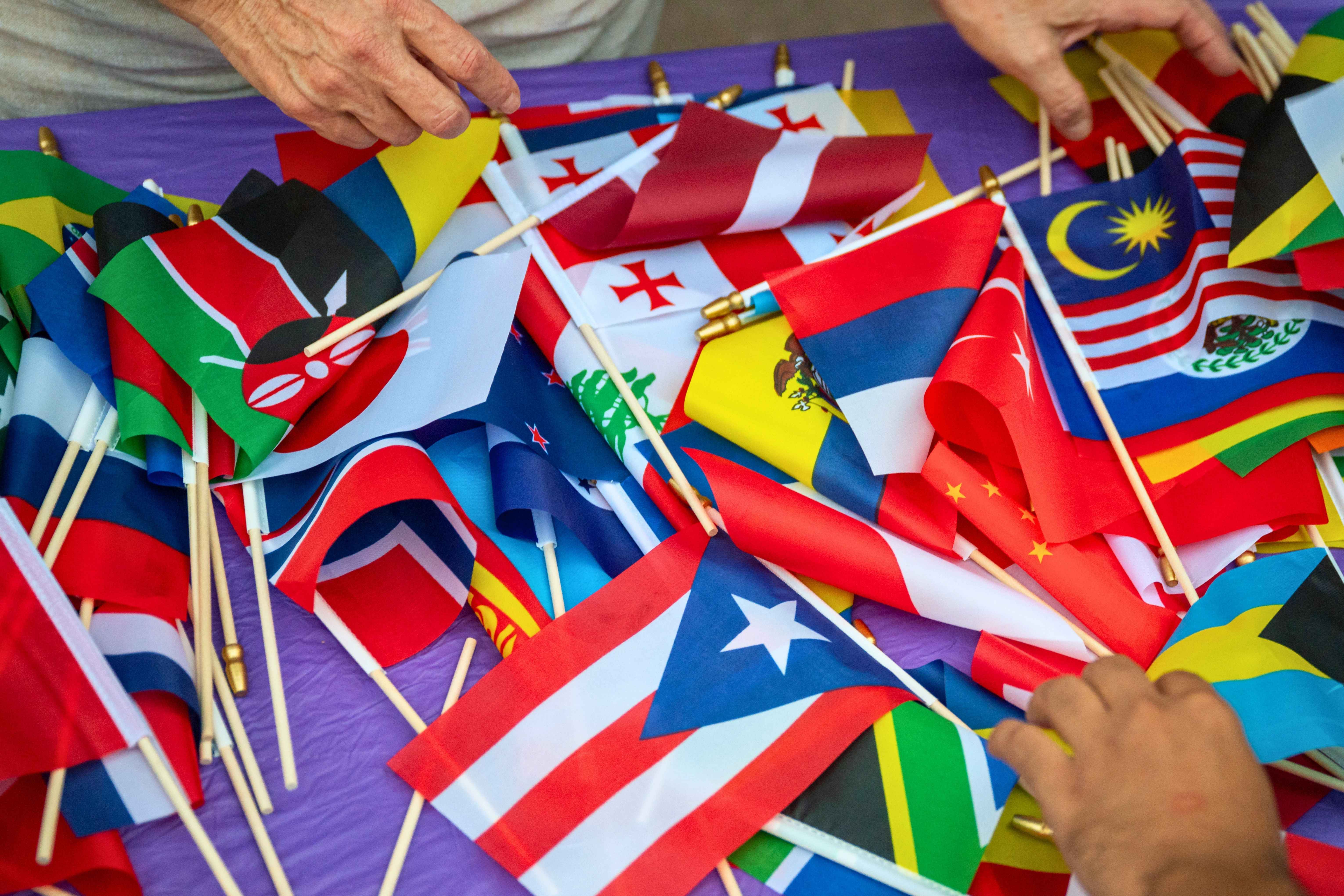 Close-up image of a table with various small international flags