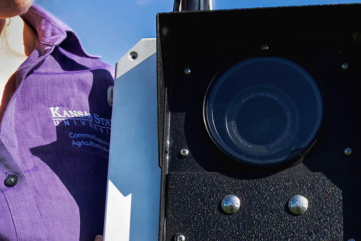 A professor holding a time-lapse camera.