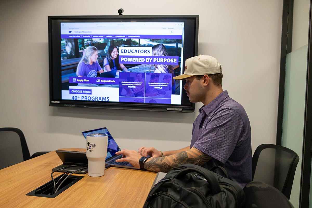 A male college student studies at a table.
