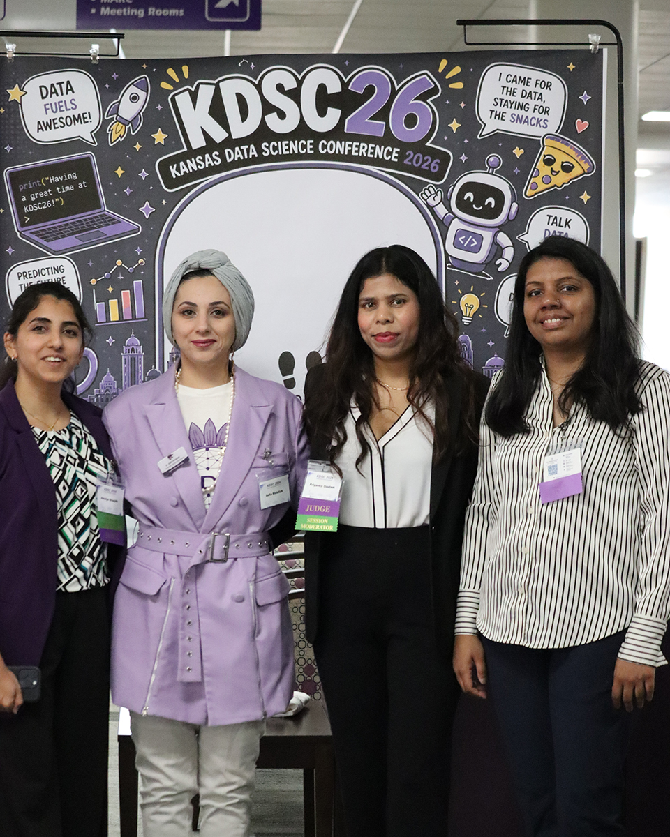A group of several women pose for a portrait.