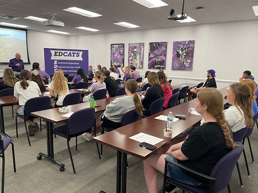 Sample Todd Goodson, professor and interim dean of the College of Education, speaks at the front of a college classroom with the newly-formed group of ED ASTRA education majors and discussed his experiences in rural education and the impact teachers can have in rural classrooms.