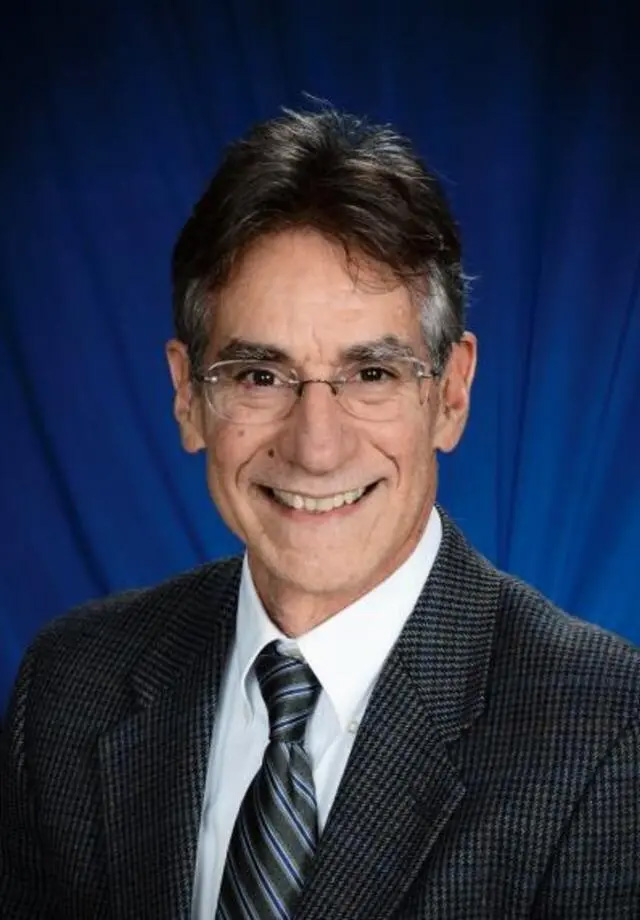 portrait of Joseph Altonji in a suit.