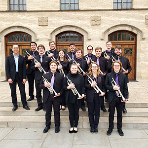 A group of trumpeters pose for a group photo.