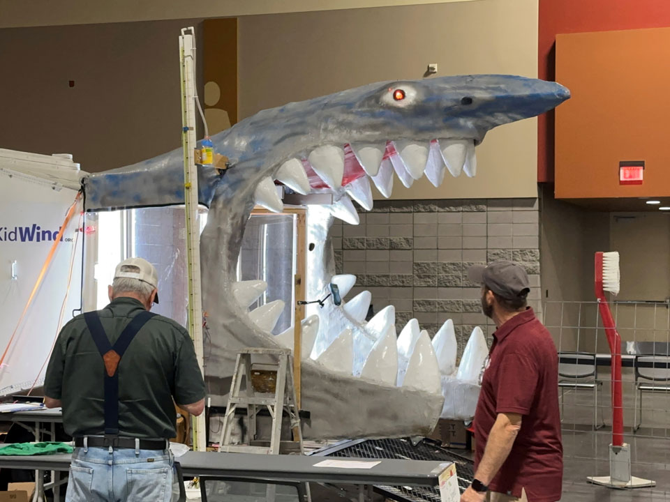 Man in red shirt looks at High-speed Shark Tunnel at KidWind Challenge