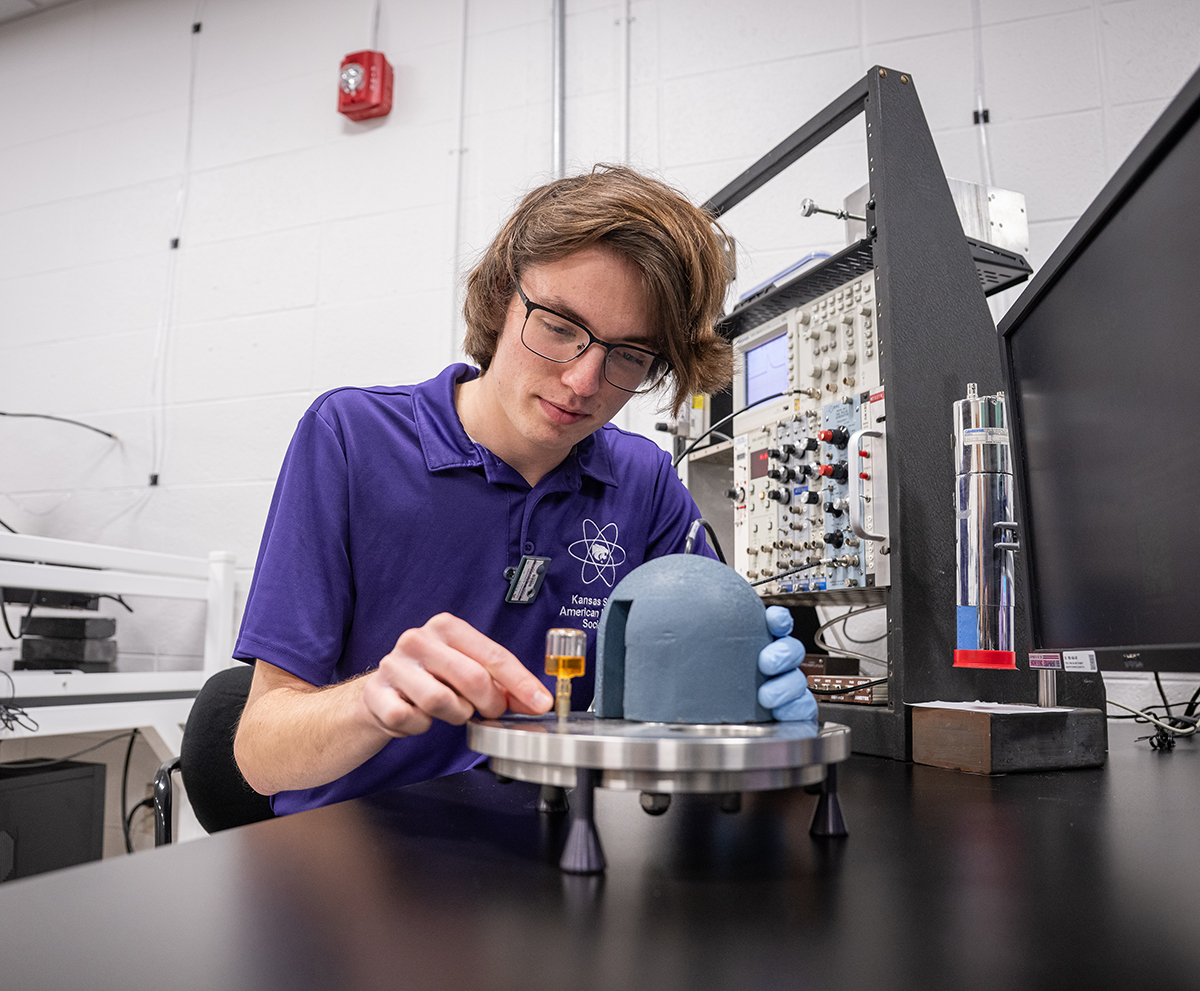 A student in safety glasses works with materials to prepare for a career in nuclear engineering.